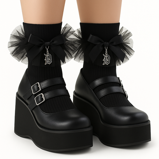 Black platform shoes with tulle bows and decorative elements on a white background