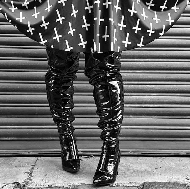 High, high hopes! A striking pair of black patent thigh-high boots paired with a playful skirt, perfect for any festival.