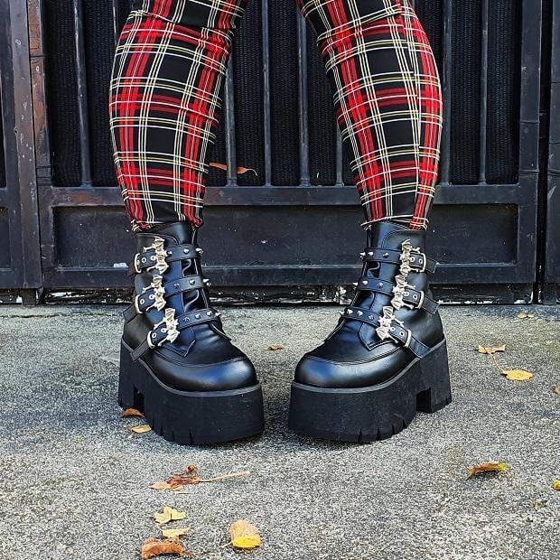 ASHES-55 Review: Stylish black vegan leather platform boots paired with plaid leggings, blending punk and comfort.