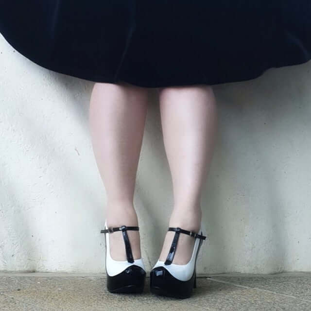 Teeze and Delight! A stylish pair of black and white heels shown from the back, perfect for festival and rave events.