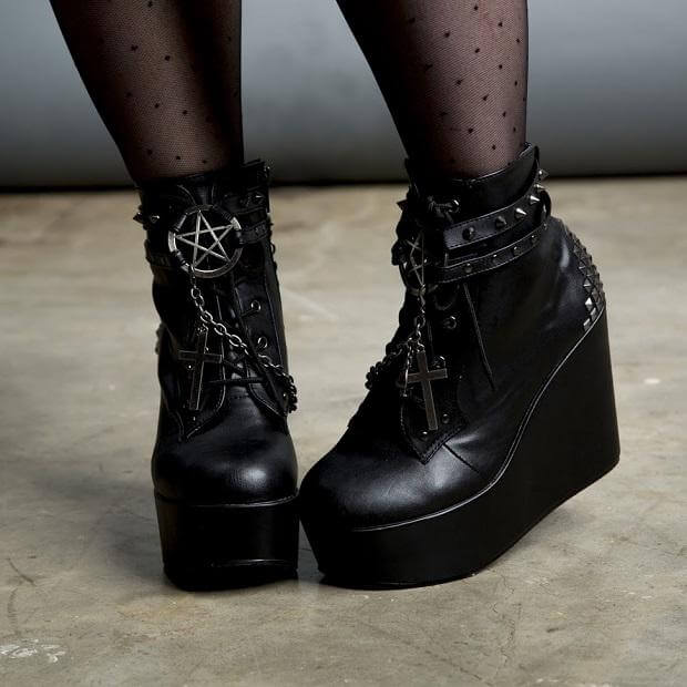 Stylish black platform boots with occult-inspired details for the perfect festival or rave outfit.