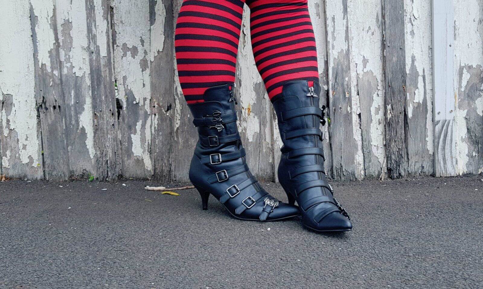 Return To Oz inspiration with stylish black buckle boots and striped tights, perfect for festival and rave vibes by Shoe Me.