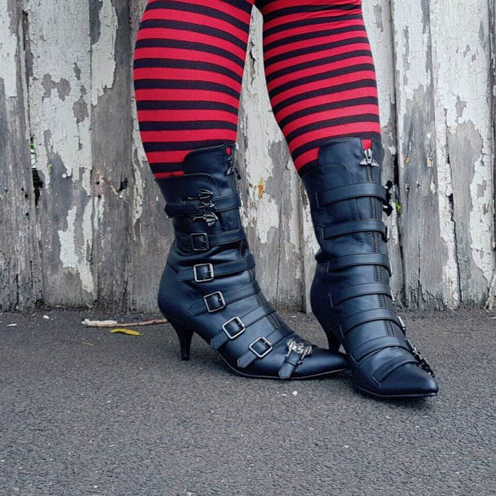 Return To Oz inspiration with stylish black buckle boots and striped tights, perfect for festival and rave vibes by Shoe Me.